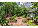 A meticulously designed backyard featuring a brick pathway and patio area with lush greenery at 315 Oakwood Ave, Raleigh, NC 27601