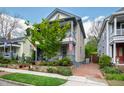Charming two-story home with covered porches, landscaped yard, and brick driveway at 315 Oakwood Ave, Raleigh, NC 27601