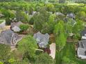 Aerial view of a home nestled among mature trees and landscaping in a quiet, established neighborhood at 341 Heather Bluffs Dr, Garner, NC 27529