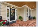 Inviting front porch with brick flooring, ample seating, and decorative details creating a warm, welcoming entrance at 341 Heather Bluffs Dr, Garner, NC 27529