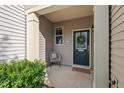 Inviting covered front porch with a chair and seasonal decor at 36 Argonaut Dr, Durham, NC 27705