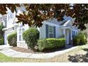 Charming home exterior featuring stone accents, lush landscaping, and a well-maintained lawn at 409 Courthouse Dr, Morrisville, NC 27560