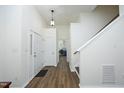Bright foyer with hardwood floors, neutral walls, and a staircase leading to the upper level at 409 Courthouse Dr, Morrisville, NC 27560