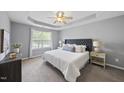 Cozy bedroom features plush carpet, tray ceilings, and natural light at 4210 Brynwood Ave, Durham, NC 27713
