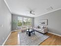Bright living room with hardwood floors, neutral paint, and a ceiling fan at 4210 Brynwood Ave, Durham, NC 27713