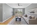 Bright living room featuring hardwood floors, modern ceiling fan, and comfortable seating at 4210 Brynwood Ave, Durham, NC 27713