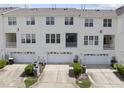 Townhouse rear view includes back patios, garages, and well-manicured lawn at 4210 Brynwood Ave, Durham, NC 27713