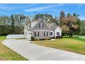 Well maintained two-story home features a large driveway, fenced in yard, and green lawn at 4304 S Greg Allen Way, Oxford, NC 27565