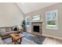 Open living room features a stone fireplace, large windows, and modern decor at 4304 S Greg Allen Way, Oxford, NC 27565