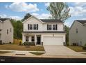 Charming two-story home featuring a two-car garage and stone accents at 501 Willard Woods Dr, Wendell, NC 27591