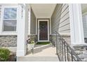 Close-up of the front entrance, complemented by a decorative wreath and stone detailing at 5217 Invention Way, Raleigh, NC 27616
