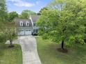 Charming two-story home with a two-car garage, expansive green lawn, and mature trees at 5424 Westminster Ln, Fuquay Varina, NC 27526