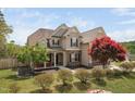 Charming two-story home with inviting front porch and beautifully landscaped front yard at 556 Rolling Meadows Dr, Clayton, NC 27527