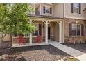 Inviting front porch featuring decorative columns and red chairs at 556 Rolling Meadows Dr, Clayton, NC 27527