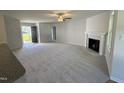 Open-concept living room featuring neutral walls, fireplace, and a front door at 58 Heatherglenn Cir, Princeton, NC 27569