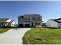 Beautiful two-story home with a spacious driveway and neatly landscaped front yard under a clear blue sky at 61 Heatherglenn Cir, Princeton, NC 27569