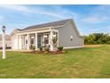 Well-maintained home with green lawn and tidy landscaping. Additional lot visible at 67 Fern Ridge Dr, Cameron, NC 28326
