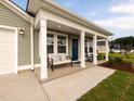 Inviting covered porch with comfortable seating, perfect for relaxing outdoors at 67 Fern Ridge Dr, Cameron, NC 28326