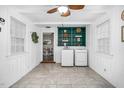 Laundry room with white washer and dryer, green shelving, and tile floor at 7110 Hunter Hill Rd, Rocky Mount, NC 27804