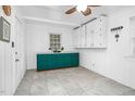 Room with white walls, tile floors, a ceiling fan and built in green and white cabinets at 7110 Hunter Hill Rd, Rocky Mount, NC 27804