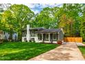 Well-maintained home with a lush lawn, complemented by green siding, a white chimney, and a private driveway at 7409 Fiesta Way, Raleigh, NC 27615