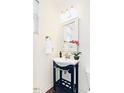 Elegant powder room featuring a pedestal sink, decorative mirror, and neutral decor at 743 Silver Stream Ln, Cary, NC 27519