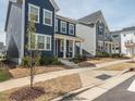 Attractive neighborhood street view showing the blue two-story home with classic curb appeal at 781 Cormiche Ln, Wake Forest, NC 27587