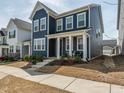 Charming blue two-story home featuring a covered front porch with lovely curb appeal at 781 Cormiche Ln, Wake Forest, NC 27587