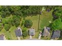 Aerial view of a well-maintained property featuring a spacious yard, fencing, mature trees, and a pool at 8016 Parker Mill Trl, Fuquay Varina, NC 27526