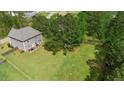 Expansive backyard featuring a lush lawn, mature trees, and a wooden fence, perfect for outdoor enjoyment at 8016 Parker Mill Trl, Fuquay Varina, NC 27526
