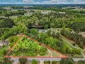 A lovely aerial view reveals lush land and the area surrounding this wonderful property at 8175 Nc 27 E, Coats, NC 27521
