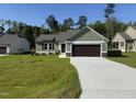 Beautiful home exterior with green siding, a spacious driveway, and a lush green lawn at 86 Heatherglenn Cir, Princeton, NC 27569