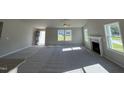 Bright living room featuring a fireplace, and large windows allowing lots of natural light at 86 Heatherglenn Cir, Princeton, NC 27569