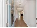 Inviting entryway featuring hardwood floors and a clear view into the living room with a fireplace at 9220 Yardley Town Dr, Wake Forest, NC 27587