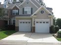 Exterior view of a two-car garage home with brick and siding, showing its symmetrical design at 9531 Vira Dr, Raleigh, NC 27617