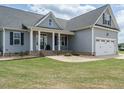 Inviting home with a manicured lawn and a stone-accented front porch, plus attached two car garage at 96 Ada Cir, Selma, NC 27576