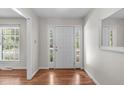 Inviting foyer features hardwood floors, white walls, and a window for natural light at 1005 Greenwood Cir, Cary, NC 27511