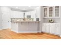 Bright, updated kitchen with white cabinets, stone countertops, and stainless steel microwave at 103 Caymus Ct, Cary, NC 27519