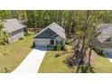 Aerial view of single Gathering home surrounded by mature landscaping and a private backyard at 103 Sunlight Cv, Louisburg, NC 27549