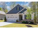 Charming single Gathering home with a two car garage, manicured lawn and front yard tree at 103 Sunlight Cv, Louisburg, NC 27549