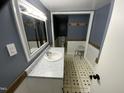 Well-lit bathroom with modern vanity, mosaic tile accents, and framed mirror, creating a fresh, clean aesthetic at 104 N 16Th St, Erwin, NC 28339