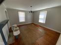 Living room boasts hardwood floors, natural light, and a decorative fireplace mantel adding character at 104 N 16Th St, Erwin, NC 28339