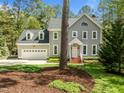 Beautiful two-story home with attached garage, and landscaped front yard with mature trees for added privacy at 105 Toynbee Pl, Chapel Hill, NC 27514