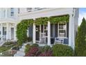 Charming front porch with rocking chairs and lush greenery framing the entrance at 1126 Russet Ln, Apex, NC 27523