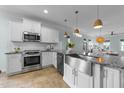 Bright, modern kitchen featuring stainless steel appliances and a stylish island with granite countertops at 1126 Russet Ln, Apex, NC 27523
