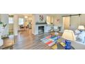 Open concept living area featuring a fireplace, kitchen, dining area, barn door and modern decor at 116 Crawford Rd, Hillsborough, NC 27278
