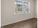 A bright and airy room with neutral walls, wood-look floors, and neighborhood views at 125 Pisgah St, Sanford, NC 27330