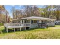 Cozy house with deck and inviting entrance, surrounded by a beautiful lawn at 13832 Nc 96 N Hwy, Zebulon, NC 27597