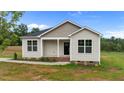 Charming one-story home featuring neutral siding, black front door and a cozy covered porch at 170 Brookhaven Dr, Spring Hope, NC 27882