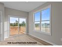 Bright living room featuring large windows, sliding glass doors to the deck, and light wood floors at 170 Brookhaven Dr, Spring Hope, NC 27882